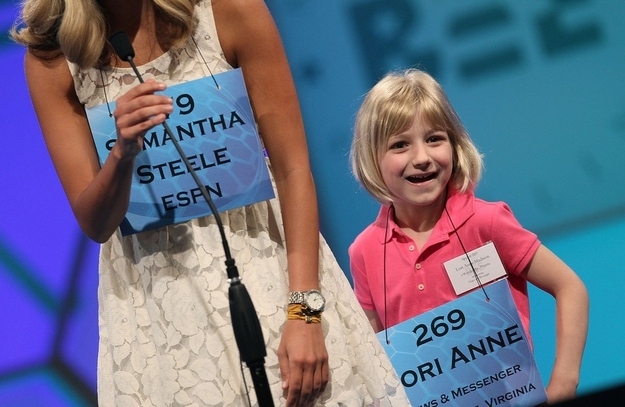 NATIONAL HARBOR, MD - MAY 30: 6-year old Lori Anne C. Madison of Woodbridge, Virginia stands with ESPN reporter Samantha Steele after the second round of the 2012 Scripps National Spelling Bee competition May 30, 2012 in National Harbor, Maryland. 278 spellers are competing in the 85th annual competition.
