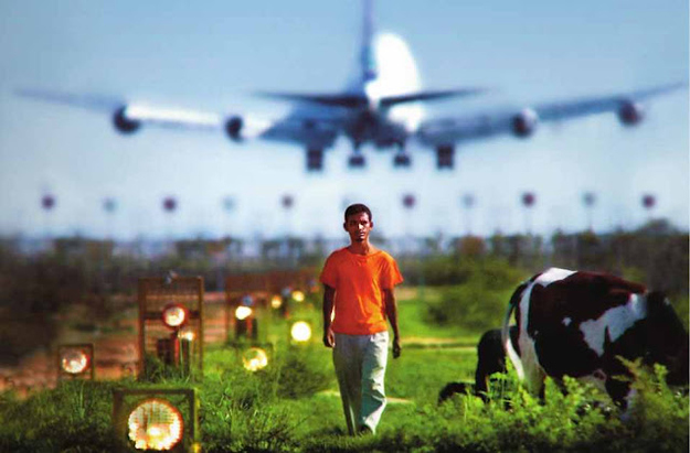 The story of the film centers around the youth Ruhul, who lives with his family in a small hut next to the runway of the international airport. His mother Rahima struggles to support the family by selling milk from a cow bought with a micro credit loan. His sister Fatima works long hours in a garments factory. There’s been no word from their father for over a month, since he left for a job in the Middle East. A madrasa dropout, Ruhul spends his days wandering under the shadow of the planes, aimless and frustrated in his futile efforts to find work. One day at a cyber café he meets Arif, a computer savvy young man who exudes confidence and a sense of purpose. The world Arif introduces him to seems inspiring and new, but eventually Ruhul’s life spirals into a nefarious netherworld of intolerance, violence and ultimately, death…
