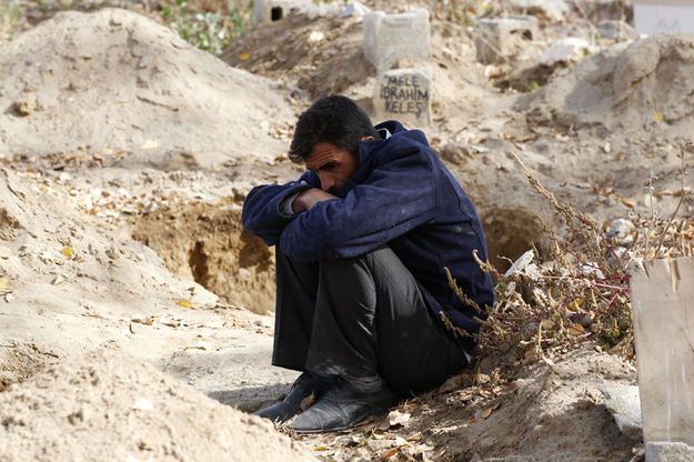 An earthquake survivor mourns at a cemetery in Ercis.