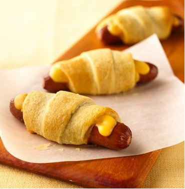 What do I need to make it?8 hot dogs4 slices (3/4 oz each) American cheese, each cut into 6 strips1 can (8 oz) Pillsbury® refrigerated crescent dinner rollsHow do I make it?1. Heat oven to 375°F. Slit hot dogs to within 1/2 inch of ends; insert 3 strips of cheese into each slit.2. Separate dough into triangles. Wrap dough triangle around each hot dog. Place on ungreased cookie sheet, cheese side up.3. Bake at 375°F. for 12 to 15 minutes or until golden brown.