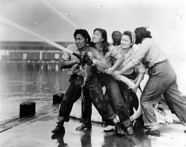 Firefighters direct a hose after the Japanese attack on the US naval base at Pearl Harbor, Dec. 7, 1941.