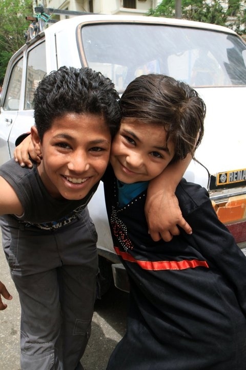 From Turnstylenews:

A brother and sister posing near Tahrir Square, where hundreds prayed before...