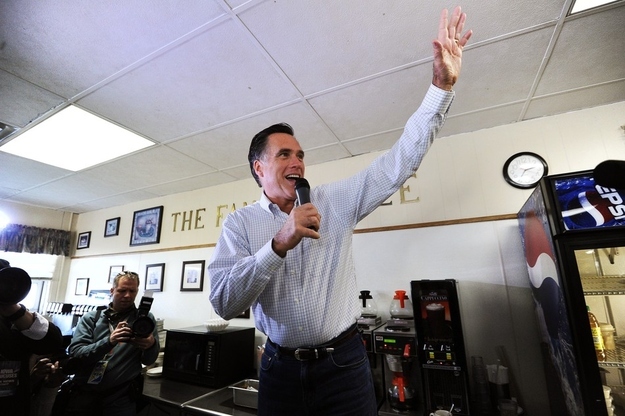 Republican White House hopeful Mitt Romney waves as he arrives at a local restaurant to meet voters in Atlantic, Iowa, on January 1, 2012. Romney held a slim lead Sunday atop the field of Republican presidential hopefuls in Iowa, going into a two-day campaign blitz before the state casts the first votes of the US election season.