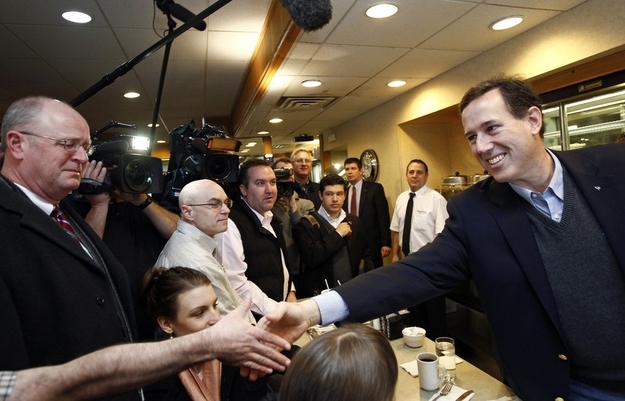 U.S. Republican presidential candidate and former Pennsylvania Senator Rick Santorum (R) greets patrons at the Rainbow Grill in Grandville, Michigan, February 28, 2012.