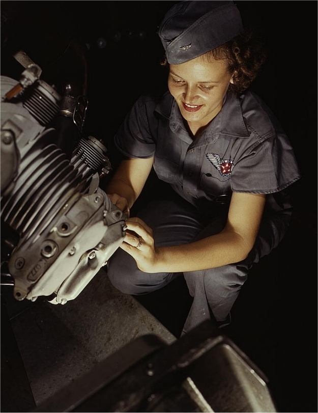 Mary Josephine Farley repairs a motor. Photographed by Howard R. Hallem in August 1942.