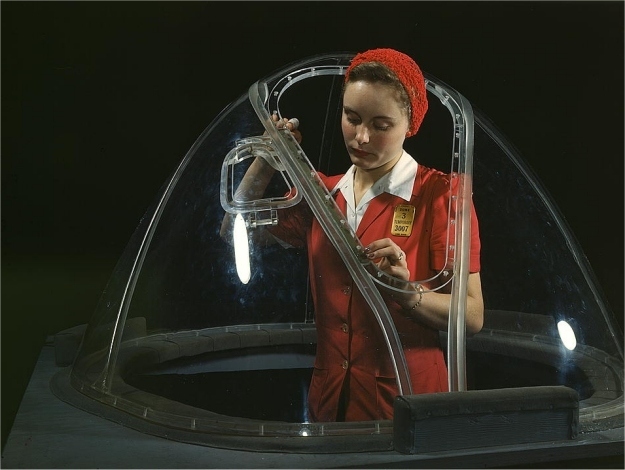 Woman completing the bombardier nose section of a B-17F navy bomber. Photographed Alfred T. Palmer in October 1942.