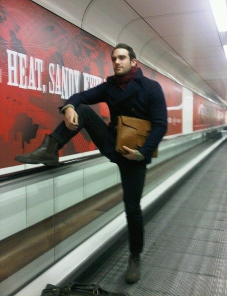 Man on the escalator having a crotch