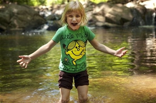 Lori Anne Madison, 6, of Lake Ridge, Va., reacts to the cold water while playing with friends in a park in McLean, Va., on Friday, May 11, 2012. Lori Anne is the youngest contestant in the 2012 National Spelling Bee.