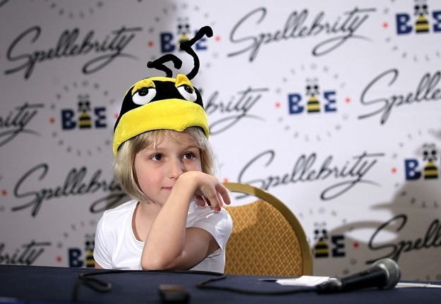 WASHINGTON, DC - MAY 31: Six-year-old Lori Anne Madison of Woodbridge, Virginia, pauses after she was told to put a bee hat on during a news conference at the 84th annual Scripps National Spelling Bee competition May 31, 2012 at the Gaylord National Resort and Convention Center in National Harbor, Maryland. Madison was the youngest competitor in the history of the Bee. She was eliminated in round 3 after she misspelled the word 'ingluvies' the day before.