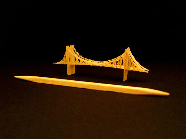 The Brooklyn Bridge created from one toothpick and glue. Dimensions: 1 3/4"(L) x 1/4"(W) x 1/2"(H)