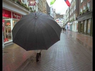We, as law-abiding citizens carrying REGULAR SIZED umbrellas, should have a responsibility to make this person aware of his/her actions. An appropriate conversation below:LACRSU: Excuse me, Mayor of this Sidewalk! PwGU: I'm sorry? I'm not the Mayor? Of this Sidwalk? LACRSU: OH, you're not? Hmm. I just thought you were because you decided to swallow it all up with your monstrous rain blanket. PwGU: O my! My umbrella! My, it is big! Thank you for bringing it to my attention! I shall remove it from the ENTIRE sidewalk at once. LACRSU: Much obliged, and do it now or I'll throw a hissy fit.