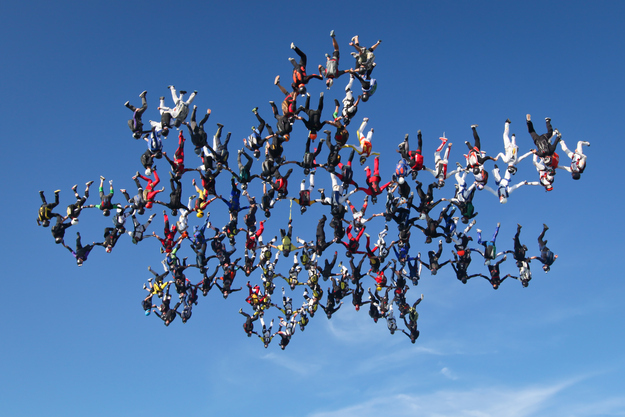 In this image provided by Brian Buckland, 138 skydivers form a massive snowflake formation Friday, Aug. 3, 2012 over Ottawa, Ill. It took them three days and fifteen tries to get it right.