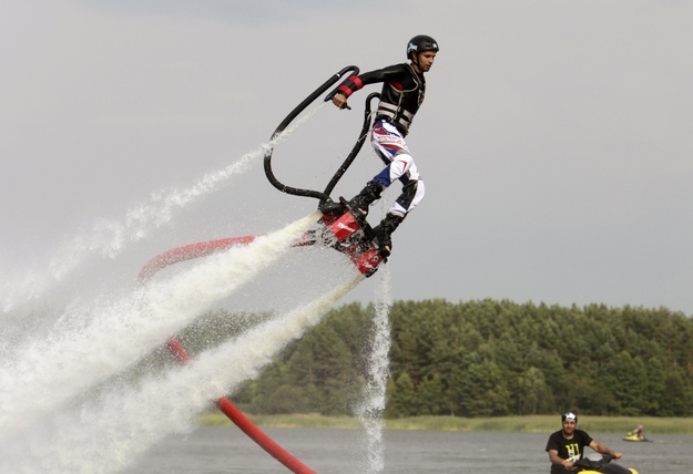 A participant demonstrates his skills using a water jet pack during a recreational sporting competition at an entertainment centre near the village of Pleshchenitsy, 70 km (44 miles) northeast of Minsk, August 4, 2012, and you spent this whole caption wondering how water jet packs exist and why you don't have one.