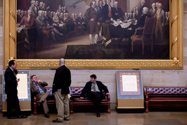 Reporters sit in the rotunda of the U.S. Capitol waiting for news on the federal budget on April 8, 2011, in Washington, DC.
