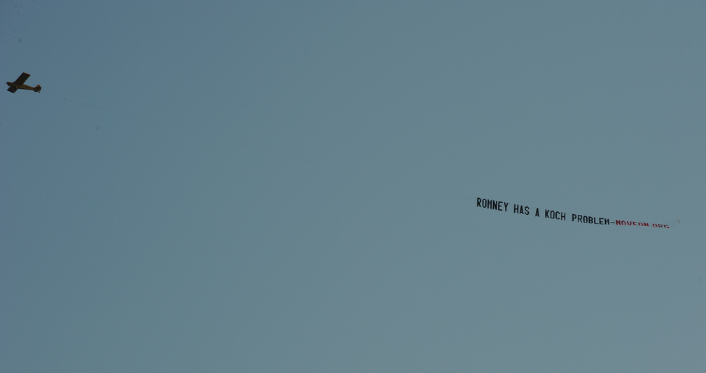 A MoveOn-sponsored plane swoops over a Mitt Romney event in July 2012.