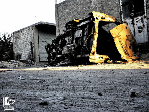 An overturned vehicle in the Essali neighborhood of Damascus.