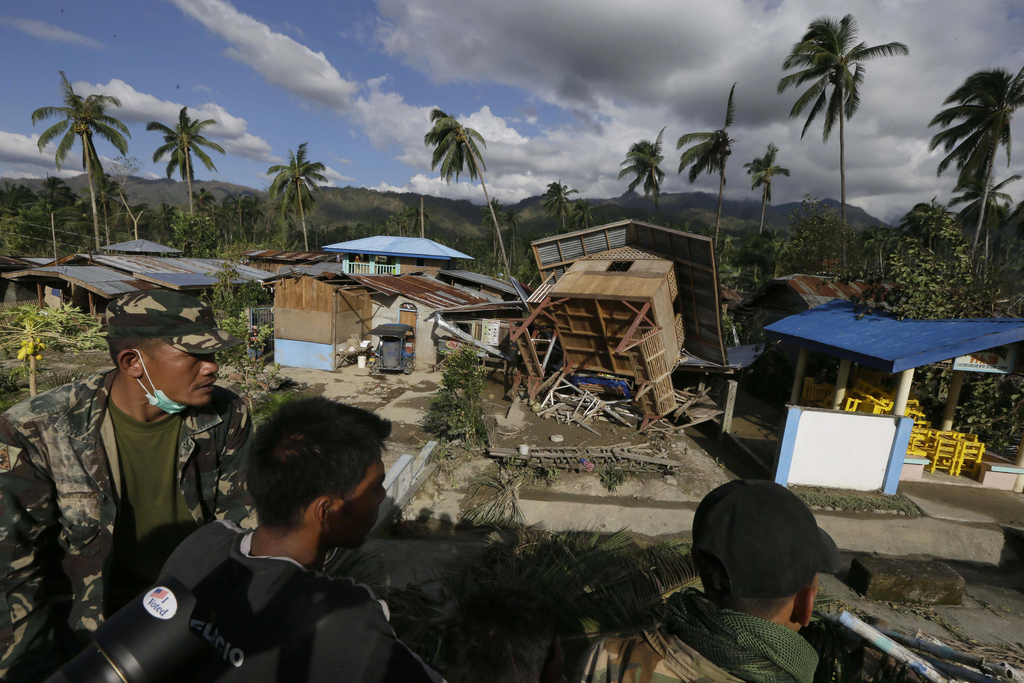 Filipino soldiers search for victims and survivors amid the devastation left by Typhoon Bopha, in the village of Andap, New Bataan township, Compostela Valley in southern Philippines, Dec. 5, 2012.
