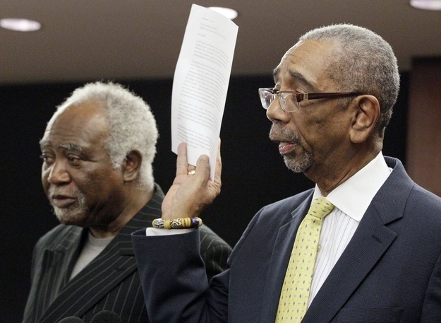 Though he barely campaigned, JJ Jr. handily won reelection for Congress with over 60 percent of the vote. However, he resigned a few weeks later. Here is Congressman Bobby Rush holding Jackson's resignation letter as Congressman Danny Davis stands by.