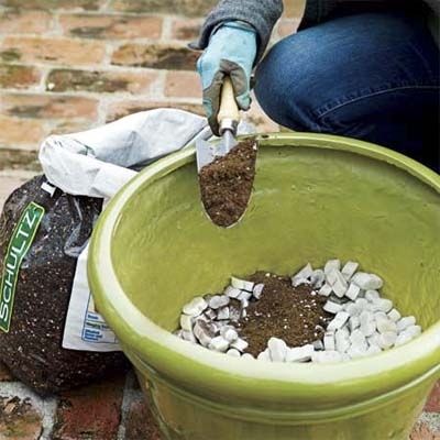 Pour peanuts into a large pot and add soil to boost drainage and make it easier to move. See more in 10 Uses for Packing Peanuts .
