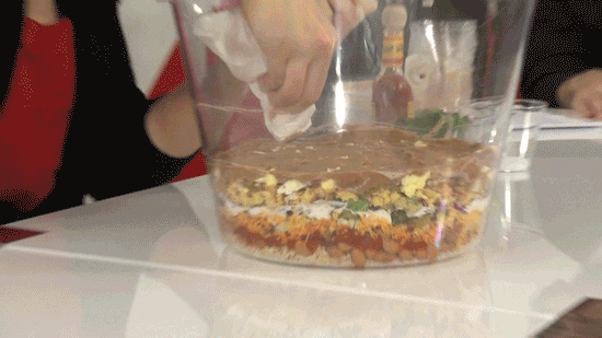 Use a paper towel to wipe the side of the bowl after adding a messy layer to maintain a clean, stratified look.