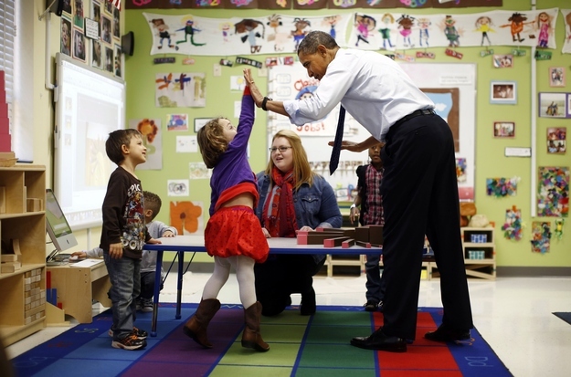 U.S. President Barack Obama high-fives children in a pre-kindergarten classroom at College Heights early childhood learning center in Decatur February 14, 2013. Obama flew to Georgia to push his plan to ensure high-quality preschool, unveiled during his State of the Union address this week.