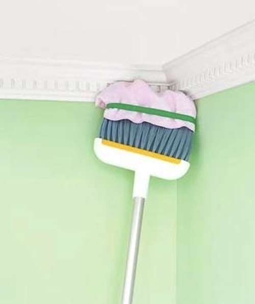 Towel + broom = a way to reach high, hard-to-clean spaces.