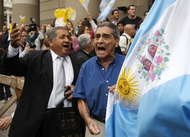 Roman Catholics celebrate the new Pope at the Metropolitan Cathedral with Argentina's flag on display.