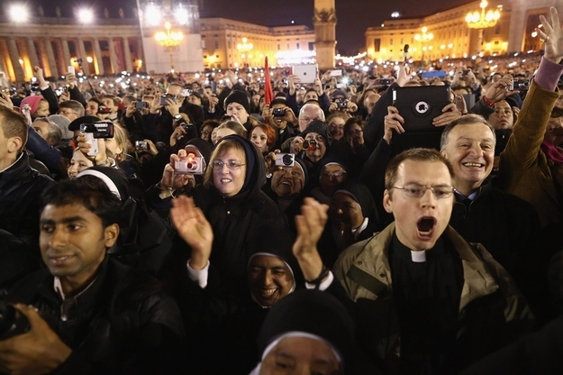 The crowd reacts as Pope Francis I appears on the central balcony of St. Peter's Basilica.