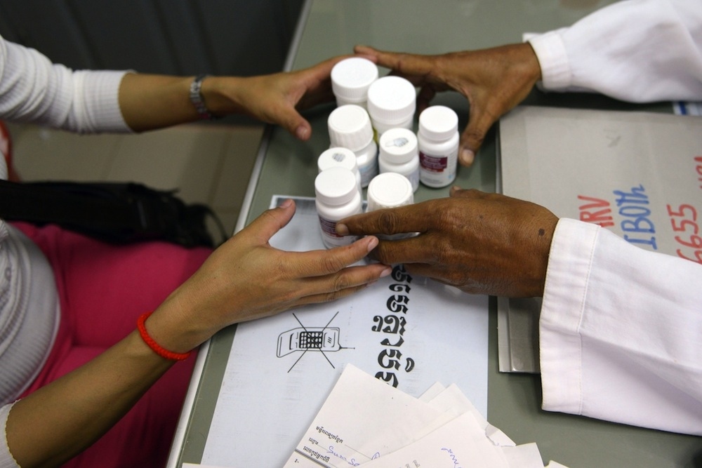 A Cambodian doctor offers Anti Retro Viral (ARV) drugs to a woman living with HIV at the Khmer-Soviet Friendship hospital in Phnom Penh in November 2012.