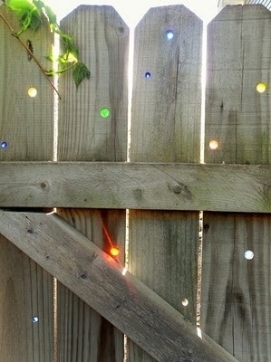 Drill holes in your fence and fill with marbles.