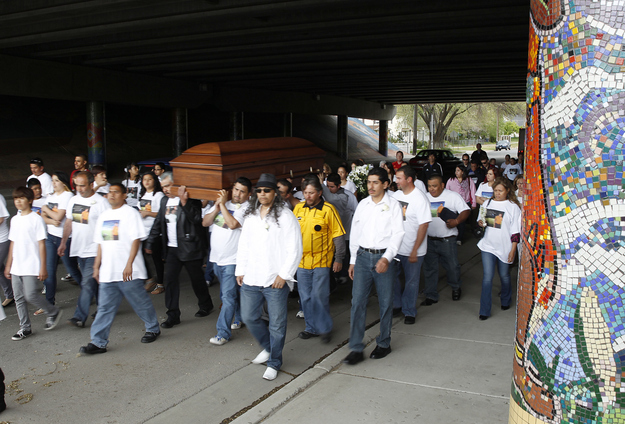 Pallbearers, family and friends carry the casket of Ricardo Portillo through the streets of Salt Lake City to a local church for his funeral.