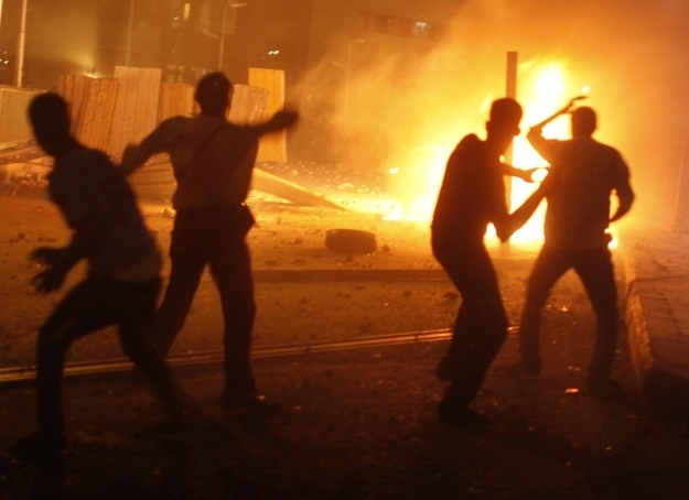 Opponents of former Egyptian President Mohammed Mursi clash with pro-Morsi supporters near Tahrir Square in Cairo July 5.