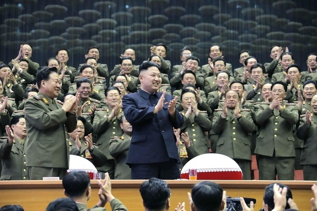 Military officials applaud together with Kim Jong-un, during the Unhasu concert in Pyongyang this year.