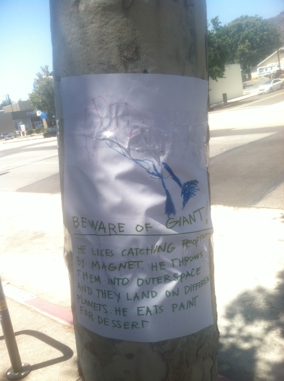 It reads: Beware of Giant! He likes catching people by magnet. He throws them into outer space and they land on different planets. He eats paint for dessert.