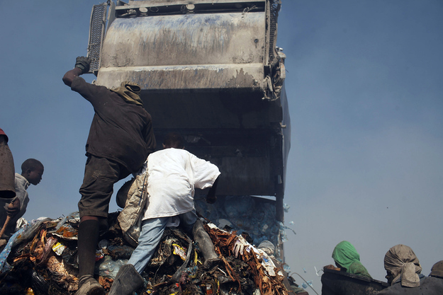 Children and adults scavenge for recyclables and other usable items around a garbage truck at the Trutier dump on the outskirts of Port-au-Prince, on March 7, 2012 in Port-au-Prince, Haiti. Following the devastating earthquake two years ago that killed and estimated 316,000 people, the number of scavengers at the landfill has grown from about 200 to an estimated 2,000. Much of Haiti is still in a crisis situation with tens of thousands living in tent camps in and around Port-au-Prince. A growing concern to international donors is a flare-up between ex-members of Haiti's armed forces and the current Haitian President Michel Martelly.