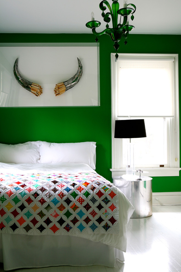 Hard to say what's cooler-- the antique windows quilt or the horns mounted on the wall. Room designed by Cortney and Robert Novogratz on HGTV.