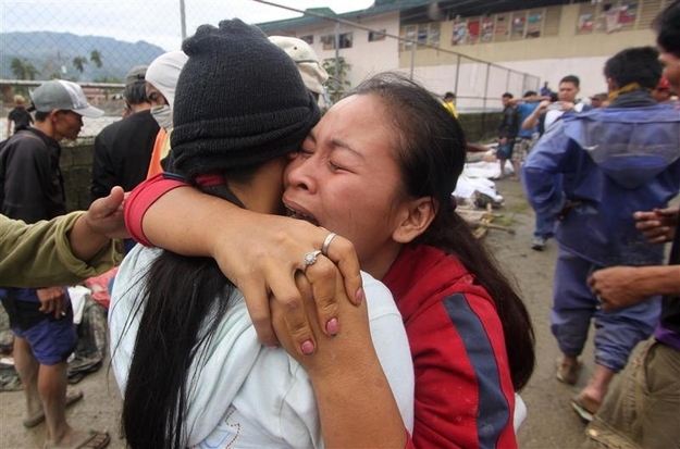 A woman cries after identifying a relative who was one of the flash flood victims after Typhoon Bopha hit New Bataan in Compostela province, southern Philippines, Dec. 5, 2012.