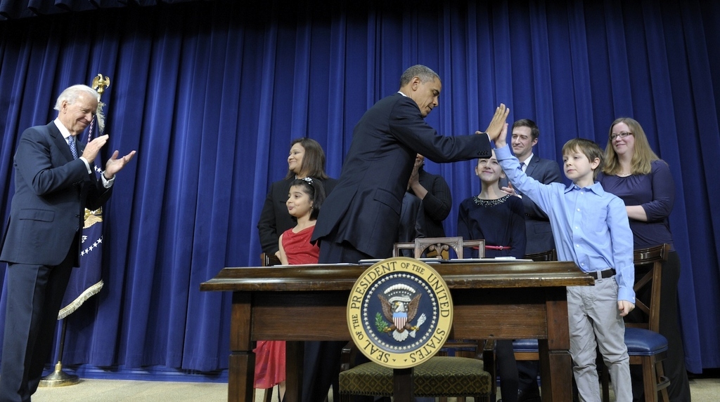 President Obama high-fives 8-year-old letter writer Grant Fitz.