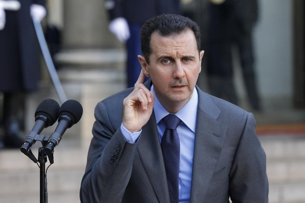 Syria's President Bashar al-Assad answers journalists after a meeting at the Elysée Palace in Paris, Dec. 9, 2010.