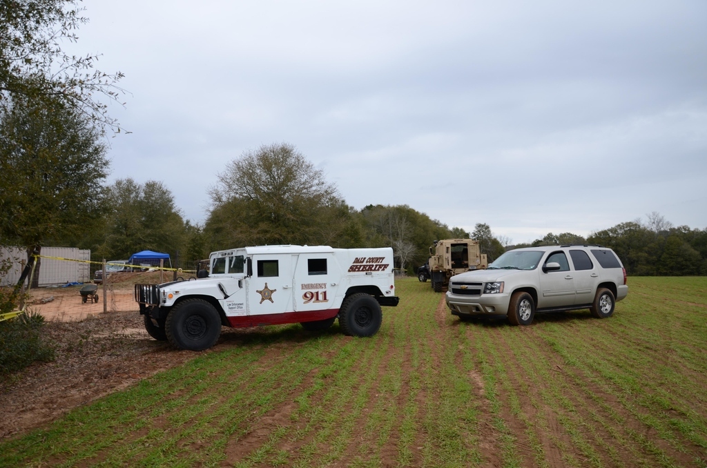 FBI agents and Dale County Sheriff’s deputies secure the residence where a 5-year-old boy was rescued after being held hostage for almost a week.
