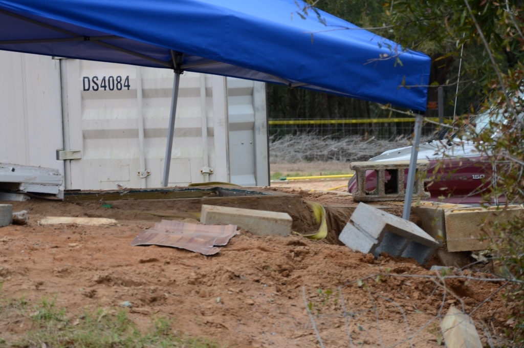 A tent covers the bunker where the 5-year-old boy was rescued by law enforcement officers. FBI agents placed the blue tent over the bunker to protect evidence below.