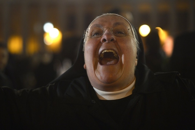 A nun reacts as Pope Francis I appears at the window of St. Peter's Basilica's balcony in Vatican City.