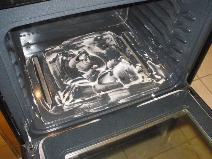 Combine a box of baking soda with water to form a paste. Fill any openings in the oven with foil. Avoiding bare metal surfaces and the oven door, spread it all over your oven then let it sit overnight. Use a plastic scraper or spatula to remove the paste, wetting as needed, then rinse with water.