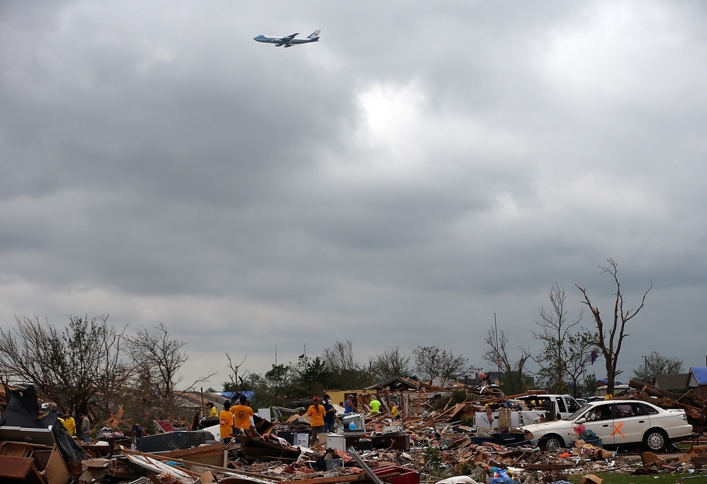Air Force One flying above wreckage.