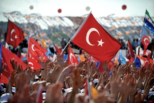 Supporters of Prime Minister Erdogan raise their hands as they gather during a rally at the Kazlicesma meeting area in Istanbul.