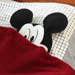 The three stages of finding Mickey Mouse in your bed: fear, wonderment, and sheer excitement. Get the pattern for this Mickey Mouse pillow here.