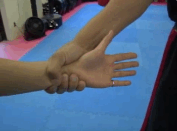 If someone grabs you by the wrist, pull your arm toward where their thumb and fingers meet (the weakest point of their grip).