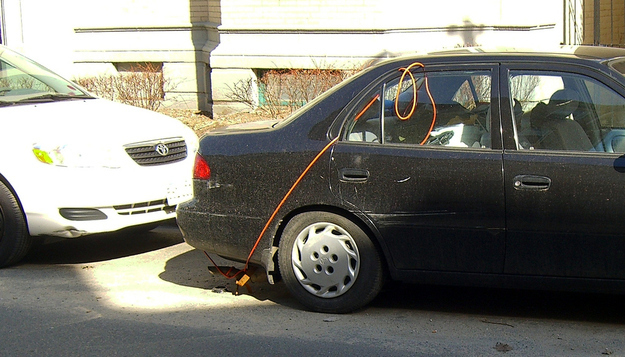 Hiring a professional is probably your best bet. Plus, your car looks a heck of a lot better without the bungee cords.