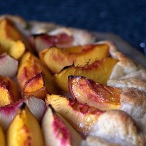 Juicy sweet nectarines bleed into a bed of crushed amaretti cookies for a simple, rustic fruit & almond tart.