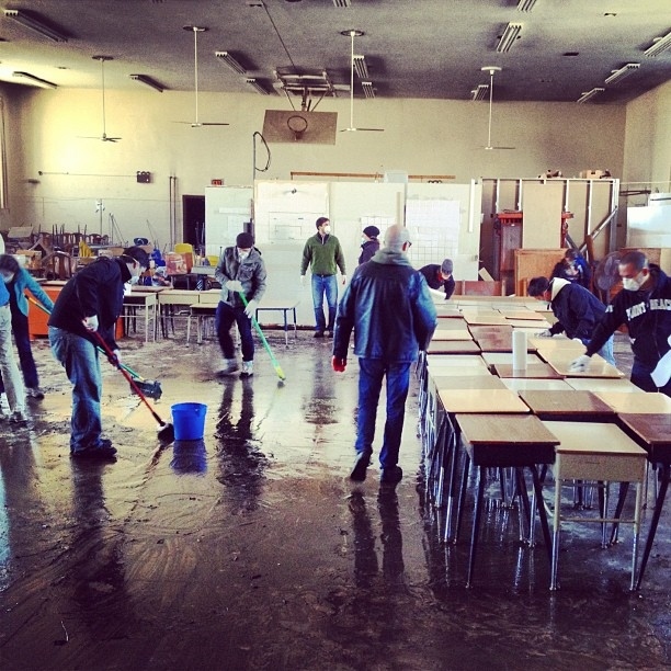 Volunteers cleaning the gym at St. Gertrude's Church in Far Rockaway, Queens to turn it into a supply distribution center.